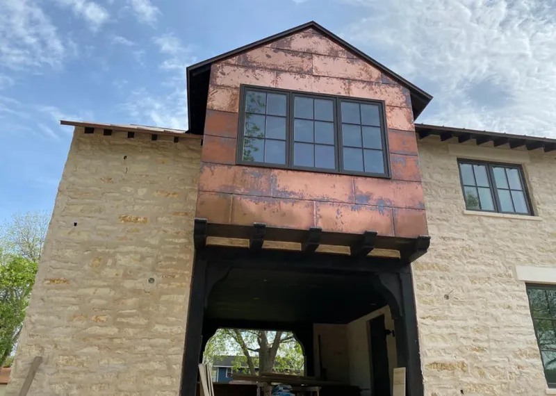 Copper metal panel facade on a stone building for Metal Roof Coating in Caldwell