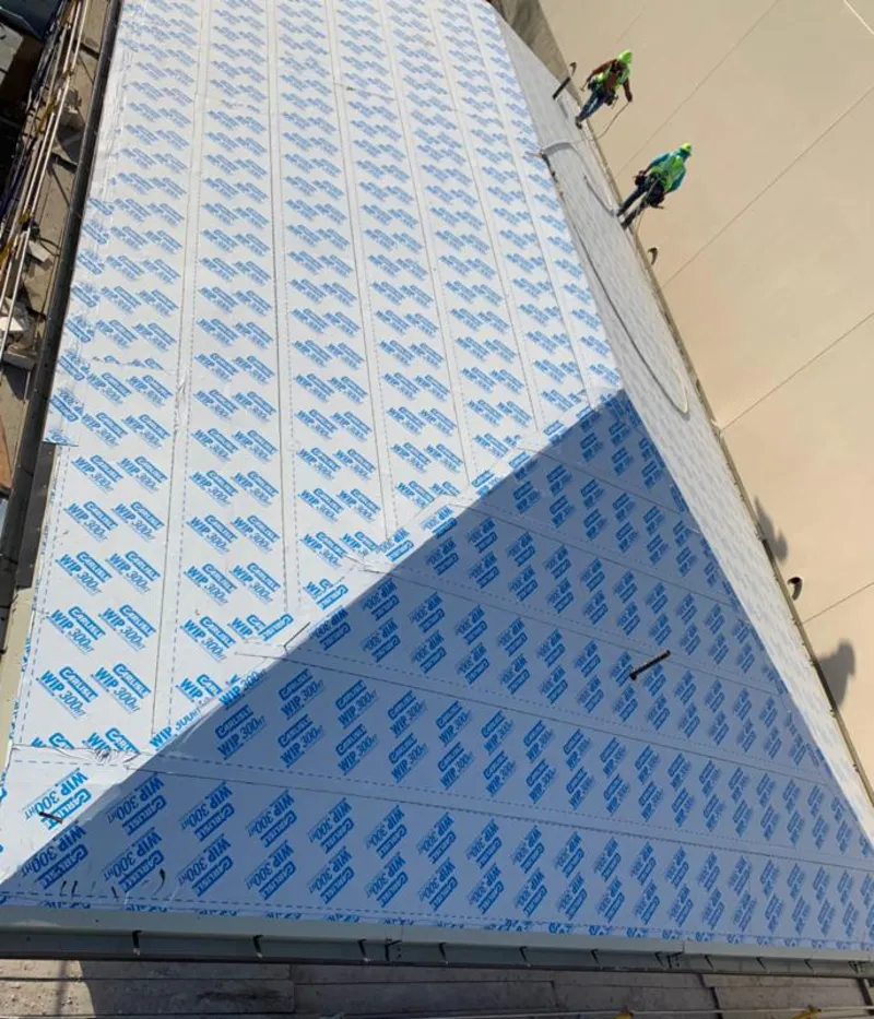 Professional roofers installing underlayment on a metal roof in Caldwell